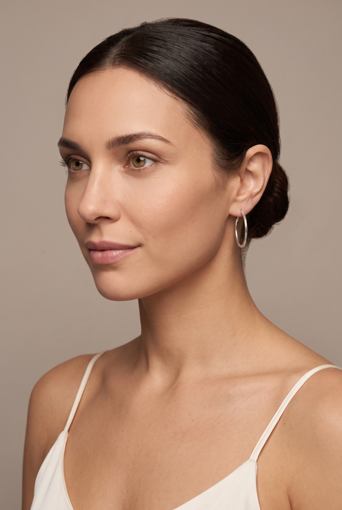 Thin 30 mm silver-tone hoop worn on the ear